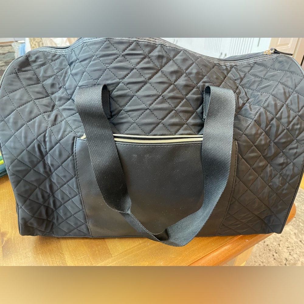 Black quilted over night bag.
